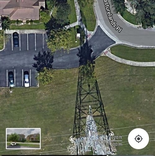 How significant is the invention of a property about 3 houses away from a power line at the top of a power tower?