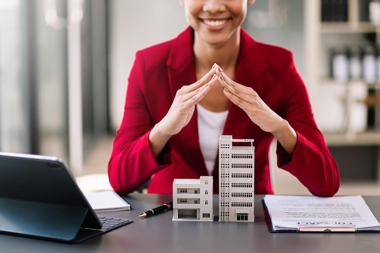 Architect reviewing plans with loan for commercial property construction